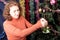 Girl decorates a Christmas tree with green bells