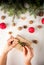 Girl decorates the gift in the Rustic style, hands in the shot.