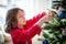 Girl decorating a Christmas tree
