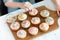 Girl decorating cupcakes on board with confetti