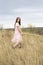 Girl in a delicate dress walks in nature