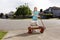 Girl delivering newspapers with a wagon in her neighbourhood