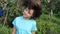 Girl demonstrates her hair on a background of garden