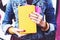 Girl in denim jacket with colorful copybooks