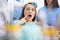 Girl in dental ambulance show sore spot