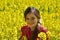 Girl with dental braces in a field with yellow flowers