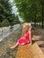 Girl dipping her feet in a fountain