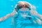 Girl dives in the pool with glasses for swimming