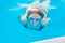 Girl dives and swims under the water in the pool with glasses for swimming