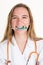 Girl doctor biting a syringe with a needle isolated