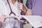 Girl Doctor in a white coat with a stethoscope and male doctor with book