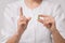 A girl doctor in a white robe holds a capsule pill with a closeup medicine for the disease