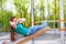 Girl does curls up on the wooden board outside