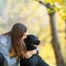 Girl with dog labrodor in autumn park at sunset