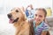 Girl with dog while parents relaxing at home