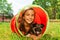 Girl with dog play in playground tube