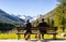 Girl and Dog Walking through Scenic Landscape of Meadows, Valleys, Mountains, and Lakes