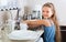 Girl doing dishes at kitchen