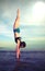 Girl doing gymnastic exercises in vertical completely with the h