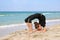 Girl doing sports exercises on beach