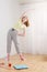 Girl doing sports at home, electronic scales on the floor