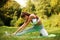 Girl doing stretching exercises in park, fitness outdoors