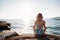 Girl doing yoga at beach, at sunset time. Healthy lifestyle