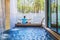 Girl doing yoga fitness exercise for relax and meditation at poolside Inside in the house,during meditation with a orange juice