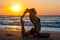 Girl is doing yoga, sitting in One-Legged King Pigeon pose, Eka Pada Rajakapotasana on beach with first ray of sunshine