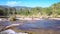 Girl doing yoga on stone against mountain river