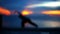 Girl doing yoga at sunset. Blurred background.