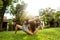 Girl doing yoga in a tropical garden