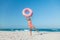 Girl with donut lilo on the beach