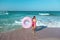 Girl with donut lilo on the beach