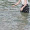 Girl with dotted dress splashing water
