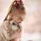 Girl with Down syndrome hugs rabbit