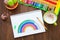 Girl draws a rainbow. Positive drawing. Art therapy and relaxation.