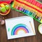 Girl draws a rainbow. Positive drawing. Art therapy and relaxation.