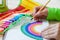 Girl draws a rainbow. Positive drawing. Art therapy and relaxation.