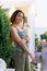 a girl with a dreadlocked hairstyle poses in the summer outdoor