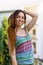 a girl with a dreadlocked hairstyle poses in the summer outdoor