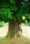 A girl dreaming under tree in rural place