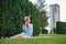 The girl dreams of a new apartment. Romantic girl with hat on picnic in park.