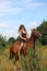 Girl in dress and brown horse portrait in forest