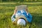 Girl in dress and hat lies on green grass reading book. View from above