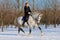 Girl on dressage horse in winter