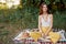 Girl dressed as a hippie eco relaxing in the park, sitting on a blanket in the sunset, relaxed lifestyle