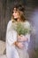 Girl dressed with large bouquets of white flowers