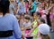 Girl dressed in a pirate costume leads roundelay with group of children