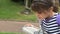 Girl drink water from drinking fountain.